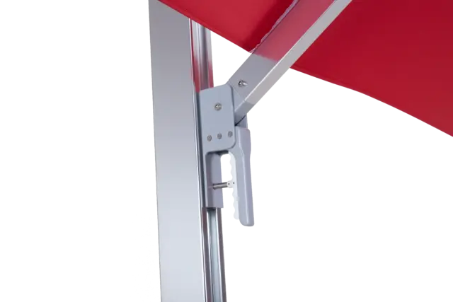 Close-up of the easy-to-use positioning handle on the Aman umbrella's mast, designed for smoothly adjusting the canopy's tilt angle.