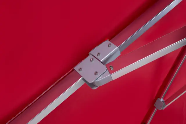 An underside view of the Aman umbrella's canopy, showing the heavy-duty central hub and reinforced aluminum rib joints for superior strength and durability.