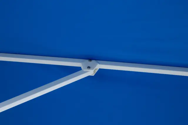 A close-up view of the durable white frame and a secure joint connection on the Frappe center-pole umbrella, showcasing the quality construction underneath the blue canopy.