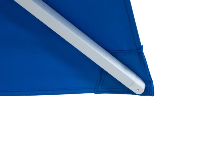 A detailed close-up of a corner of the blue Frappe center-pole umbrella, showing the reinforced pocket where the white support rib securely fits into the canopy.