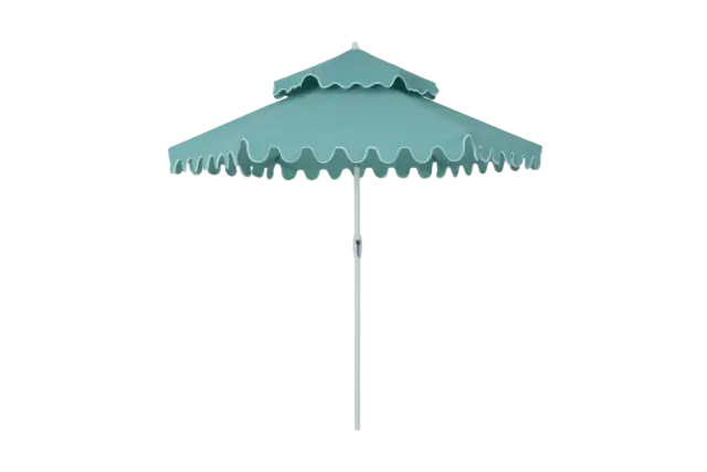 The Fugue cantilever umbrella shown with a double-tier vented top for improved air circulation, featuring its signature teal canopy and scalloped edge design.