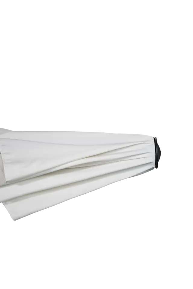 A detailed view of the top finial on the closed Istanbul market umbrella, showing the neatly folded white canopy and sleek black peak.
