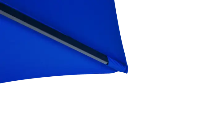 A macro shot of the reinforced corner pocket of the royal blue Luciano umbrella canopy, showing where the support rib connects securely to the fabric for enhanced longevity.