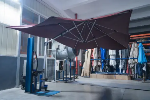 An advanced, automated overhead conveyor system transports metal umbrella components through the multi-stage surface treatment and powder coating line.